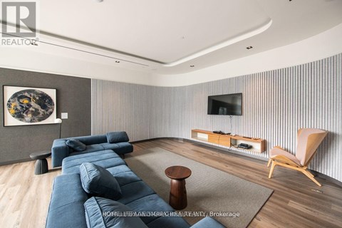A modern living room with a blue couch and a television.