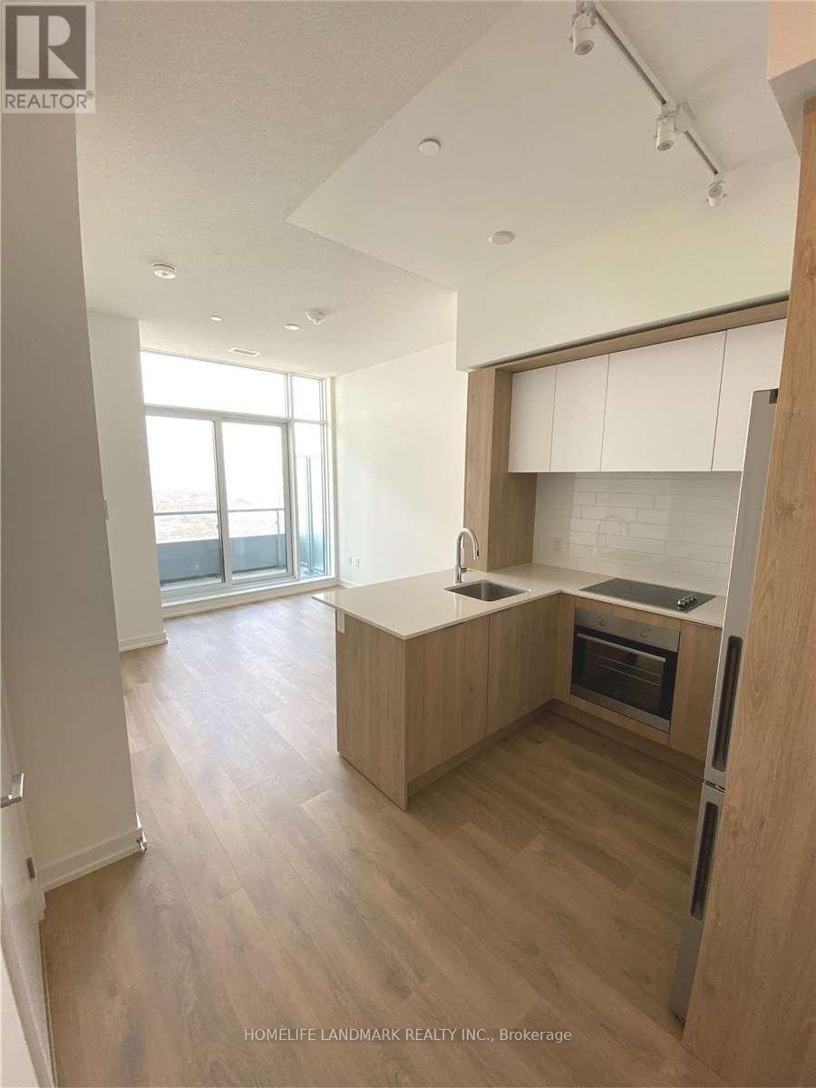 A kitchen with wooden cabinets and a refrigerator.