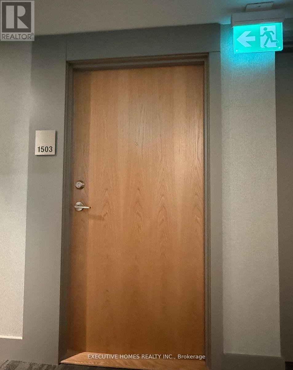 A brown door with a sign above it that says "EXECUTIVE HOMES REALTY INC., Brokerage".
