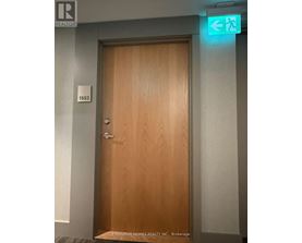 A brown door with a sign above it that says "EXECUTIVE HOMES REALTY INC., Brokerage".