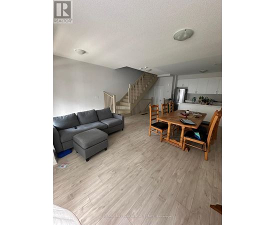 A living room with a grey couch and a wooden table.