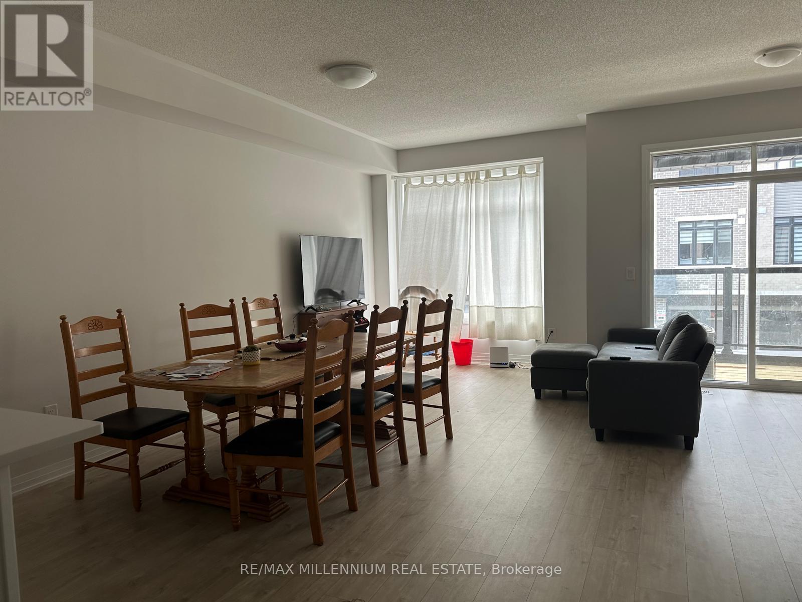 A dining room with a wooden table and chairs.