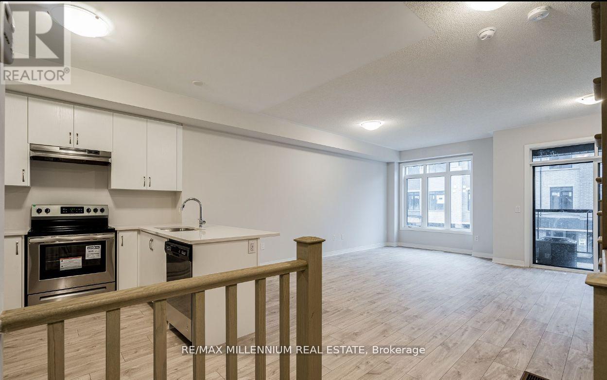 A kitchen with white cabinets and a stove top oven.