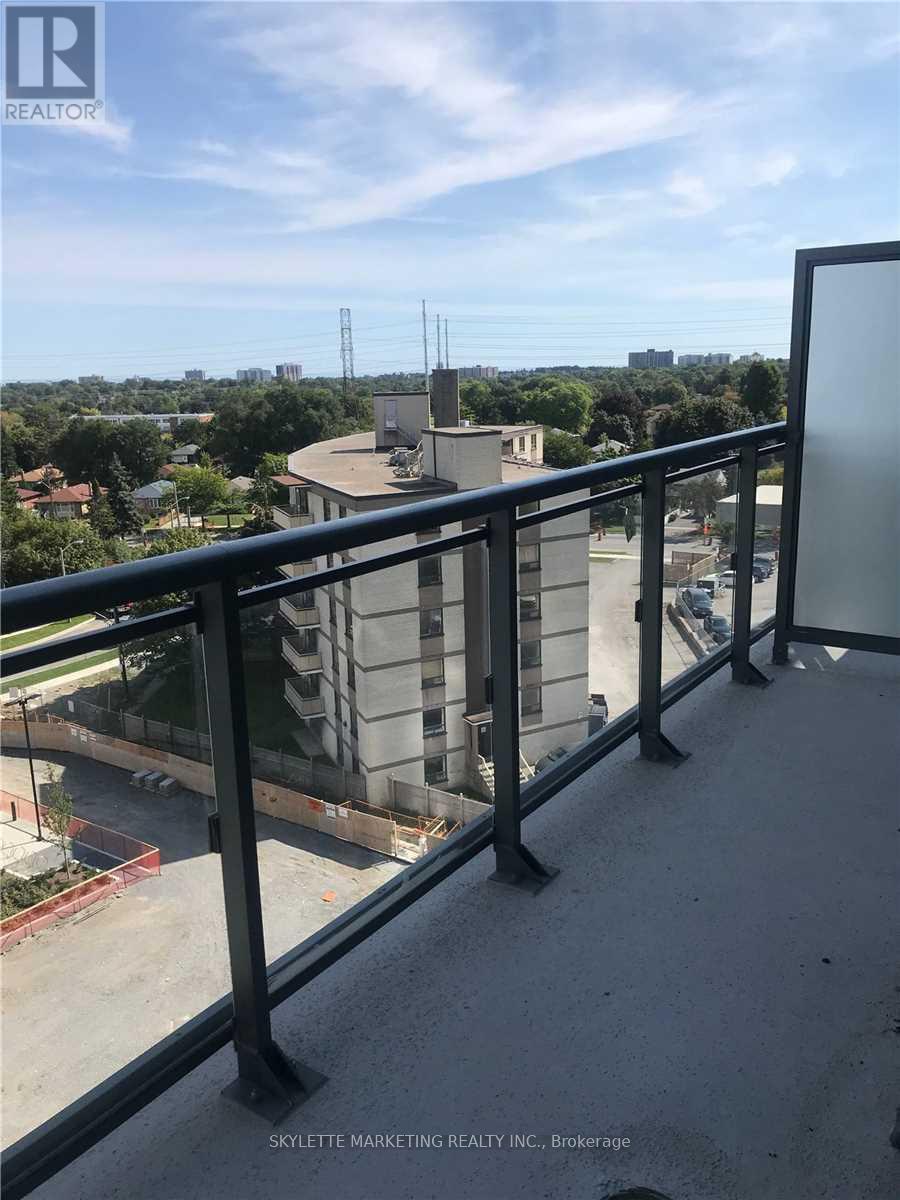 A balcony with a view of a cityscape and a building under construction.