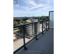 A balcony with a view of a cityscape and a building under construction.