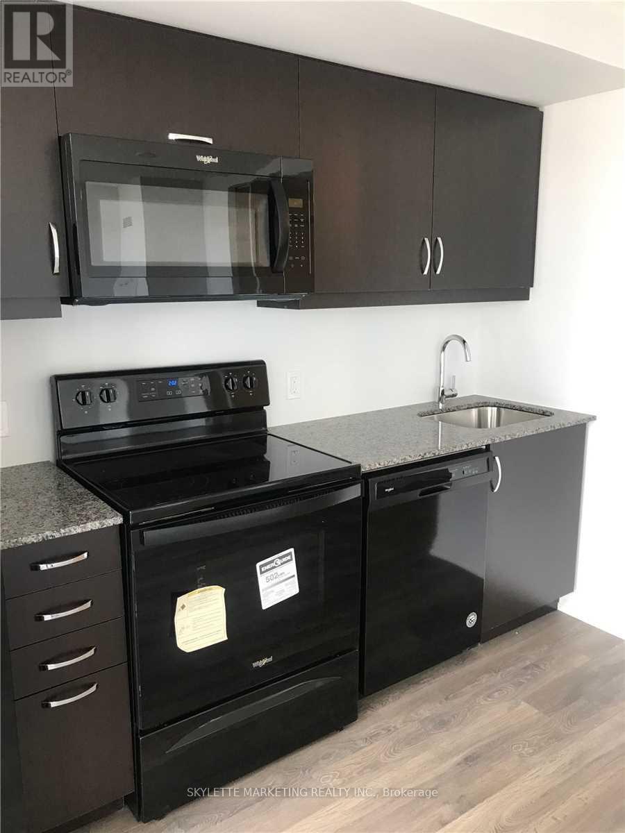A black stove top oven with a microwave above it.