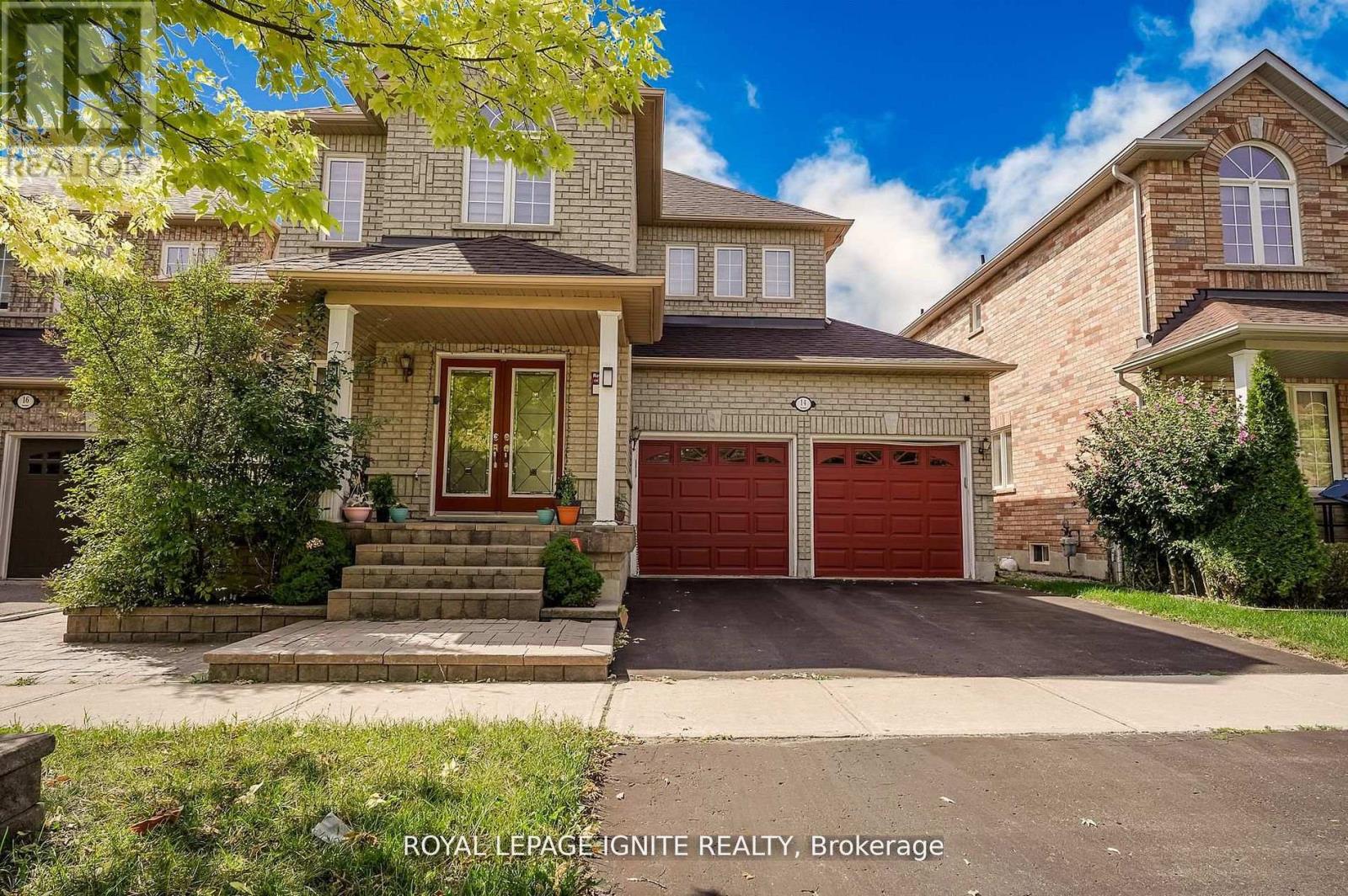 A house with a red garage door is for sale.