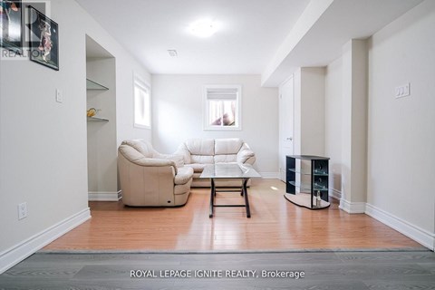 A living room with a white couch and a coffee table.