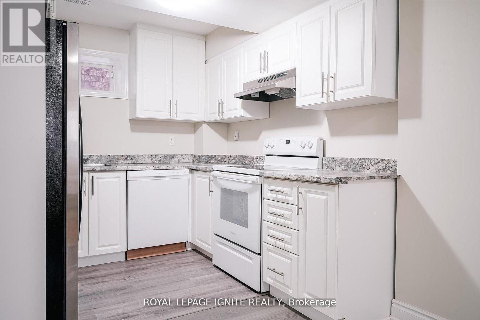 A white kitchen with a stove and cabinets.