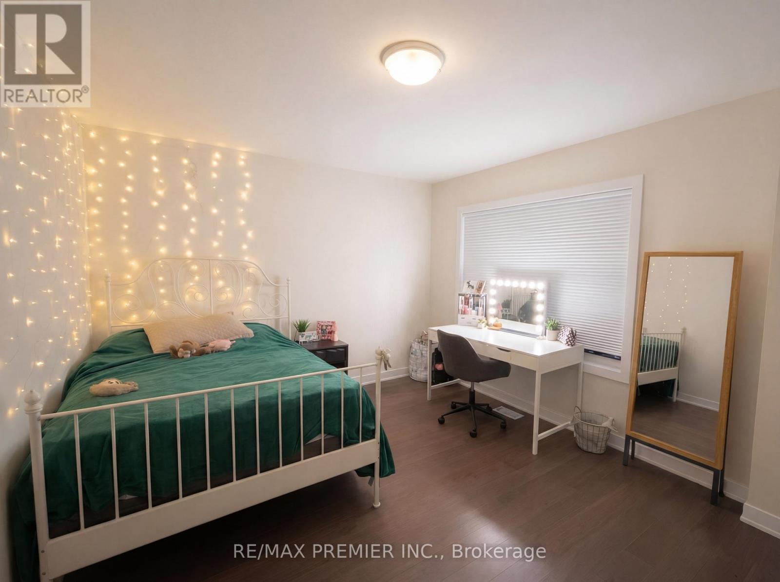 A bedroom with a bed, desk, and chair.