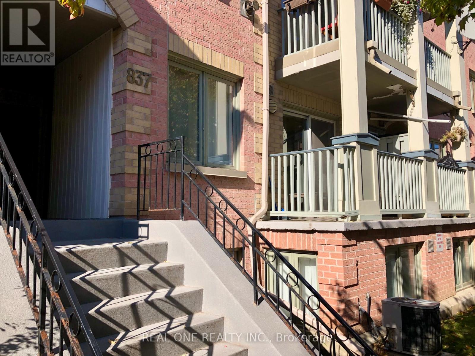 A staircase with a metal railing leads up to a doorway.