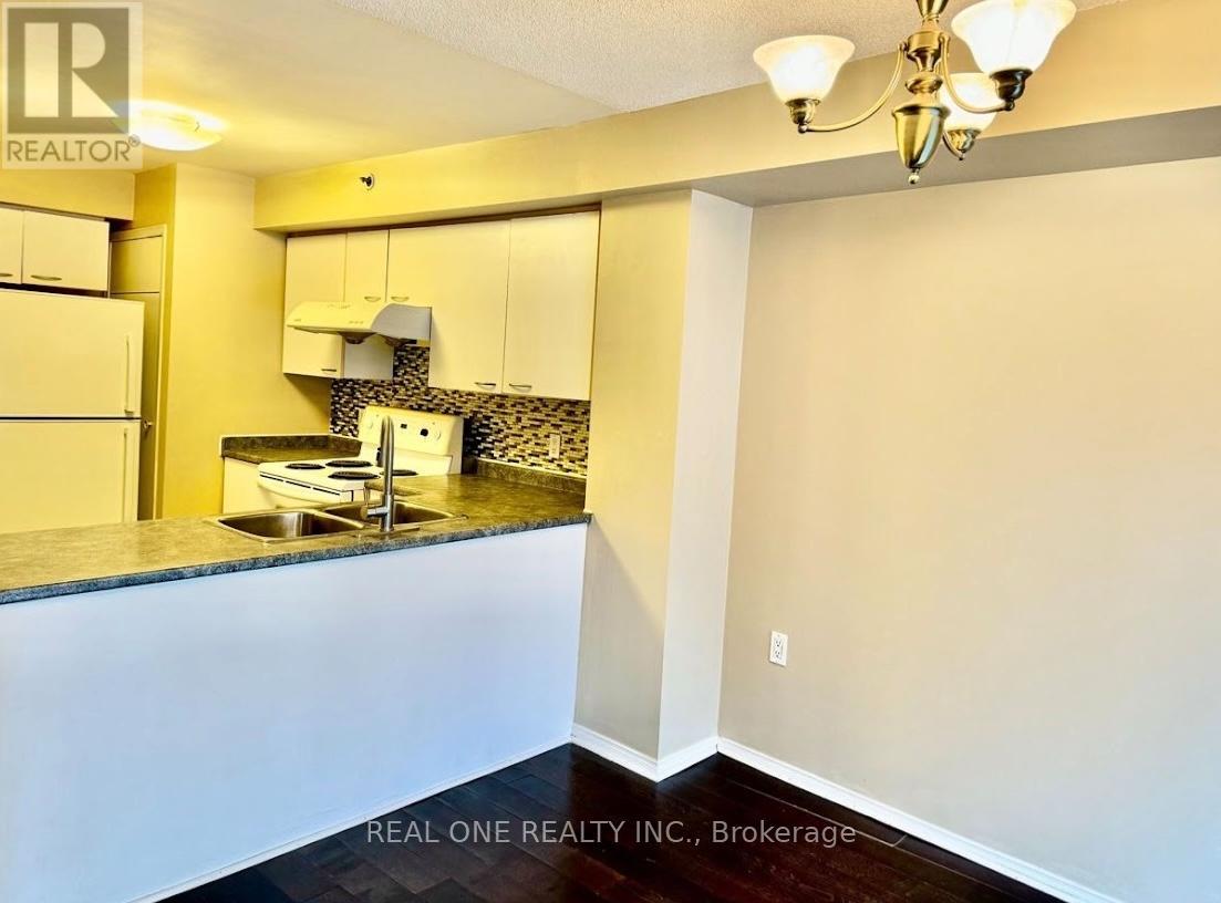 A kitchen area with a sink and a counter.
