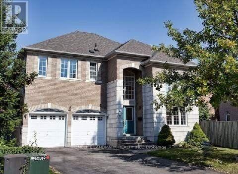 A two-story house with a garage and a driveway.