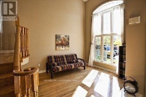 A living room with a couch and a painting on the wall.