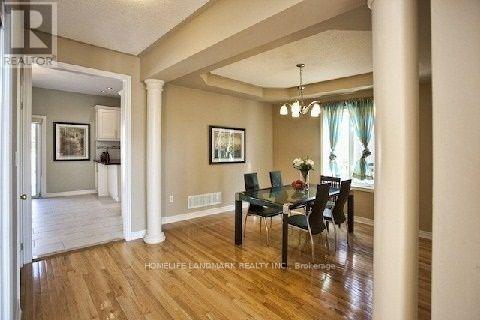 A dining room with a table set for four.