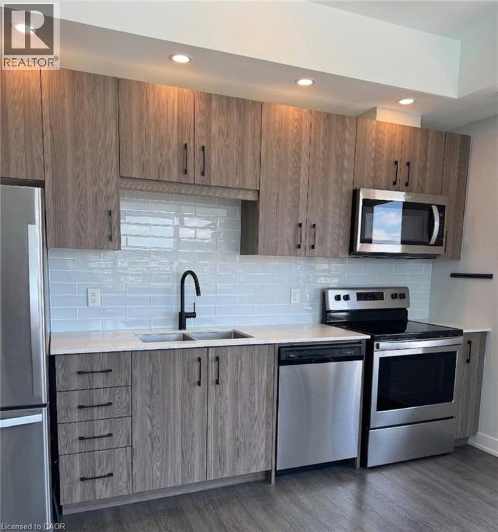 A kitchen with wooden cabinets and stainless steel appliances.
