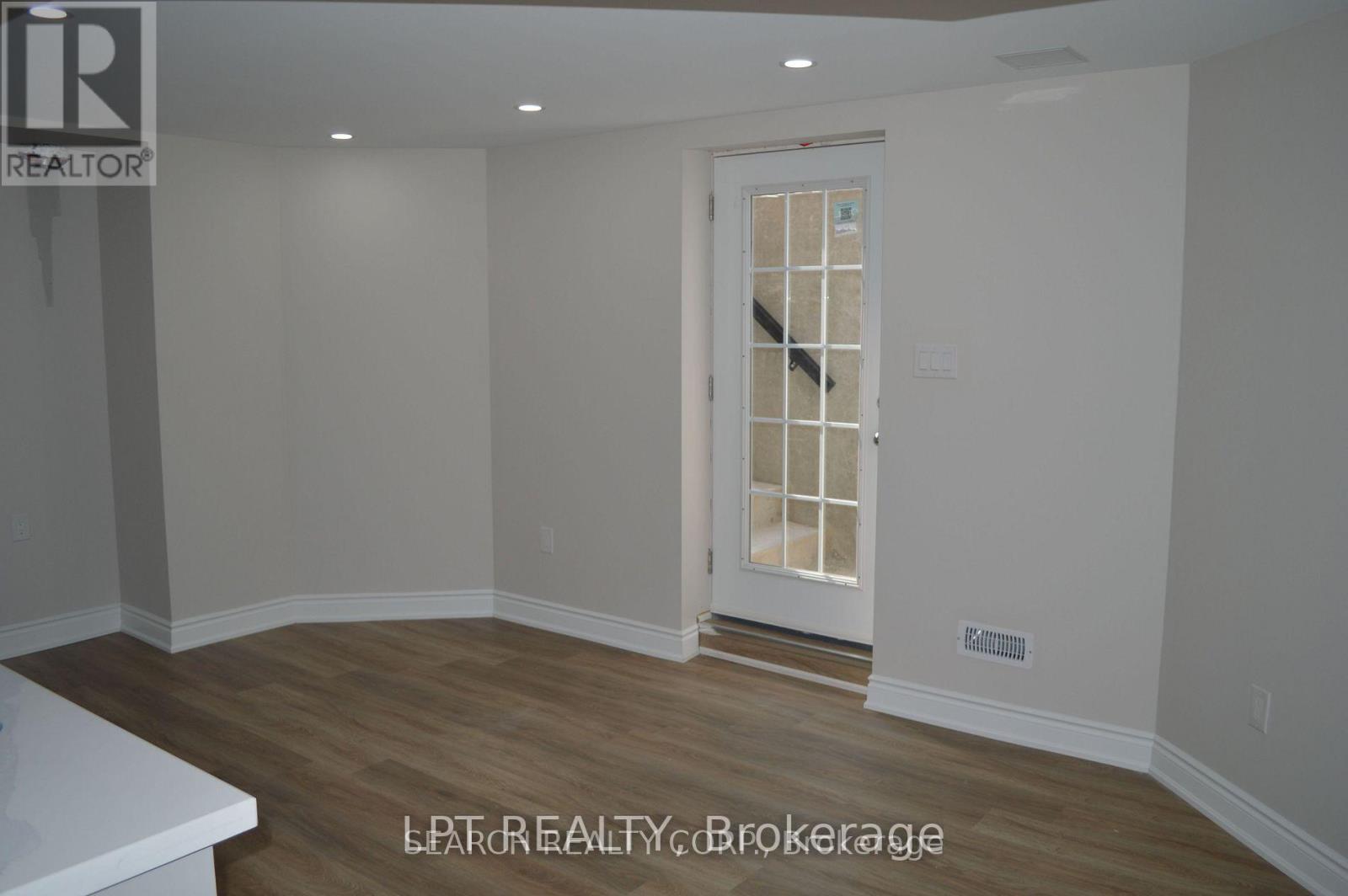 A room with a door and a wall with a logo that says "REALTOR".