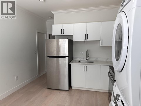 A kitchen with white cabinets and stainless steel appliances.