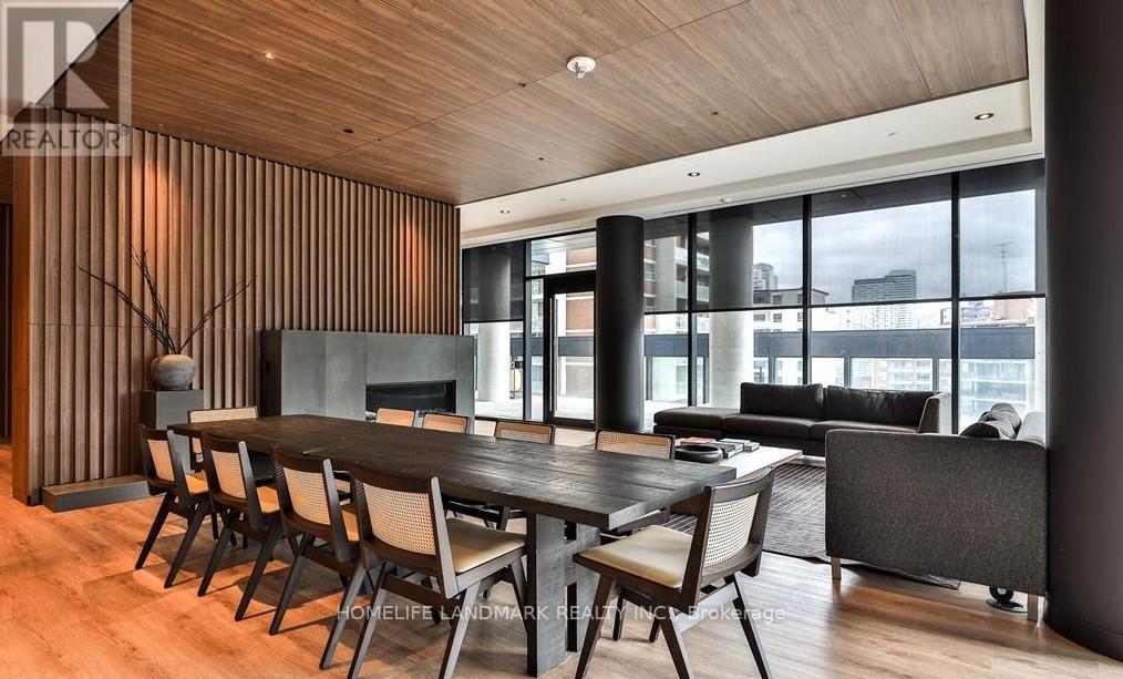 A modern dining room with a wooden table and chairs.