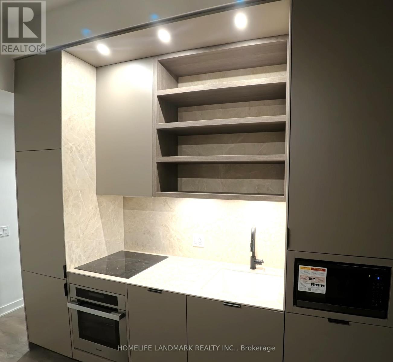A modern kitchen with a built-in oven and microwave.