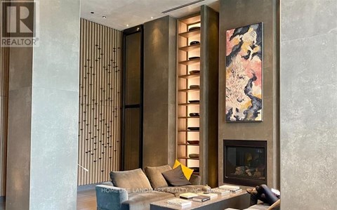 A living room with a fireplace and a painting on the wall.
