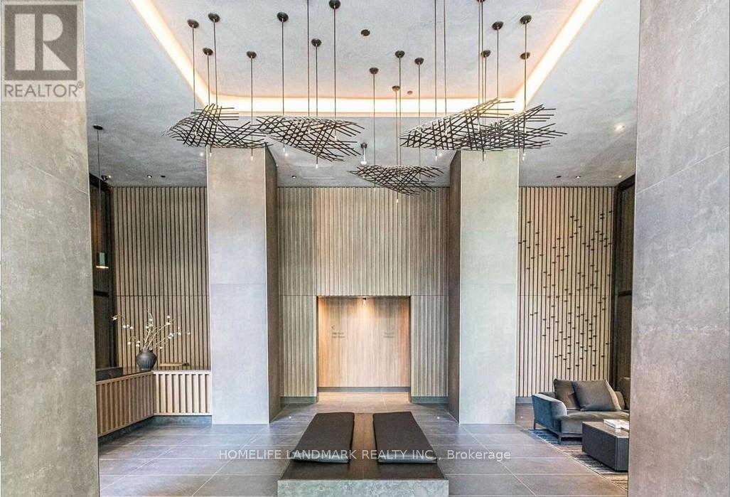 A modern interior space with a wooden wall panel and a hanging sculpture.