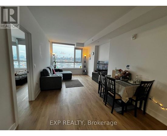 A living room with a dining table and chairs.