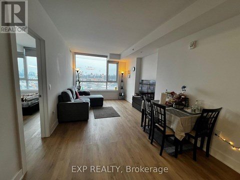 A living room with a dining table and chairs.
