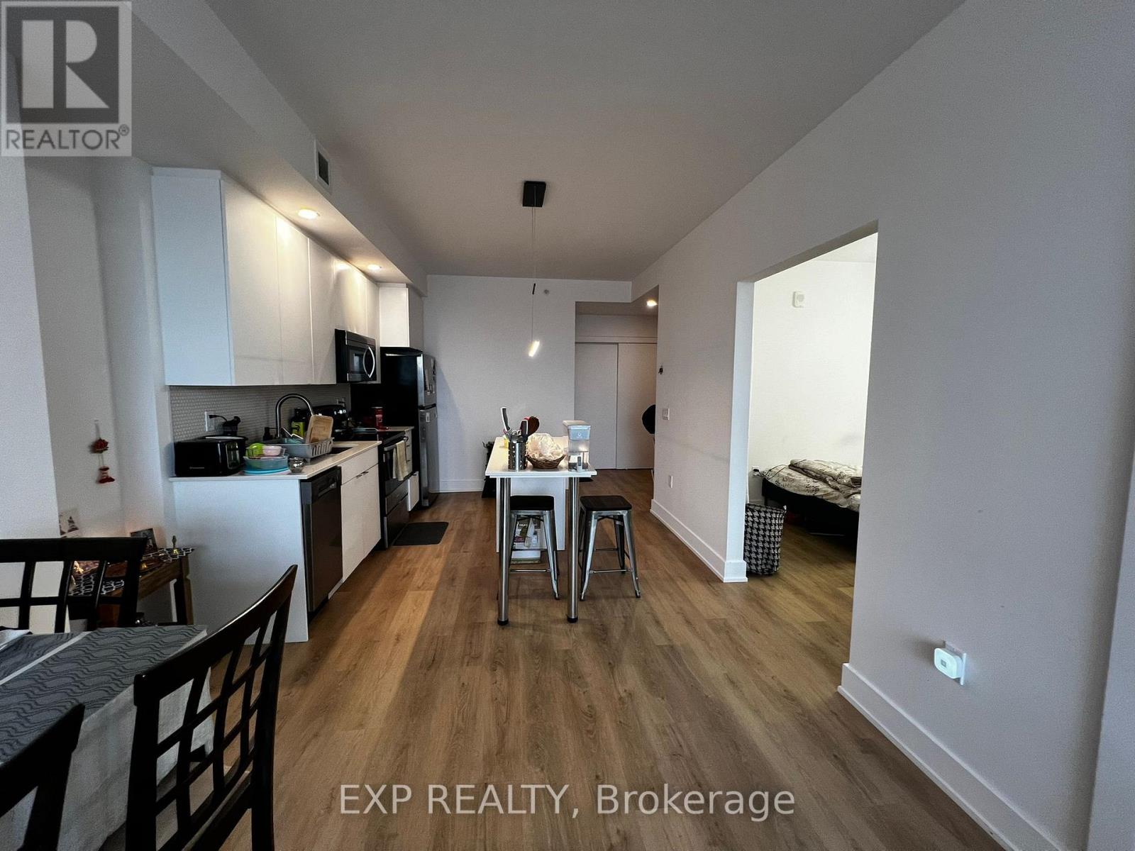 A kitchen with a dining table and chairs in the middle of the room.