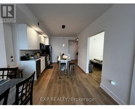 A kitchen with a dining table and chairs in the middle of the room.