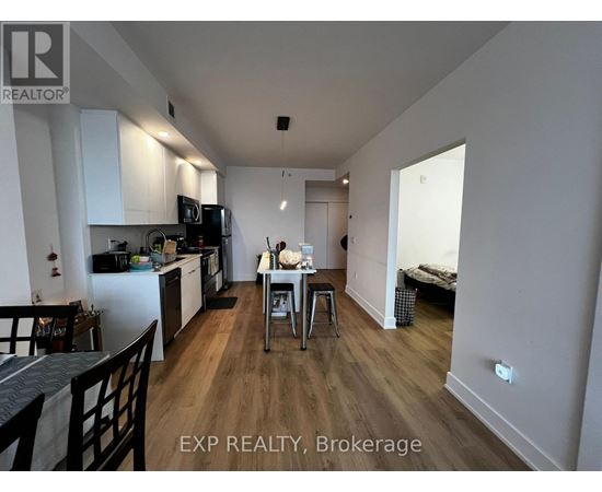 A kitchen with a dining table and chairs in the middle of the room.