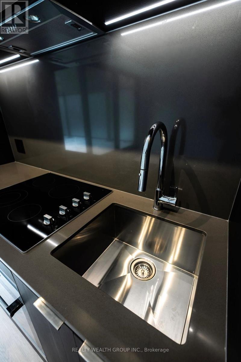A modern kitchen with a stove and sink.