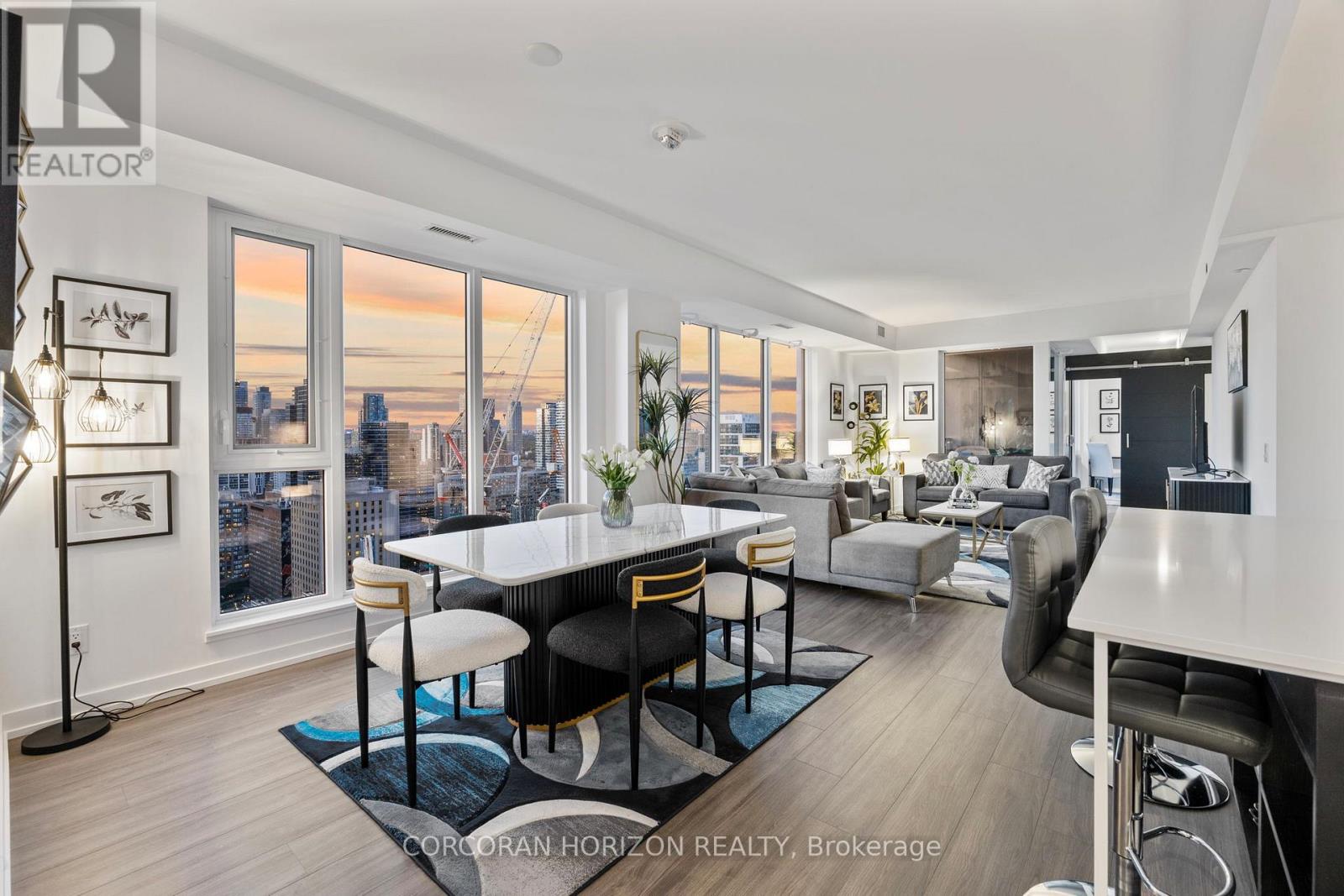 A well-lit, modern living room with a view of the city skyline.