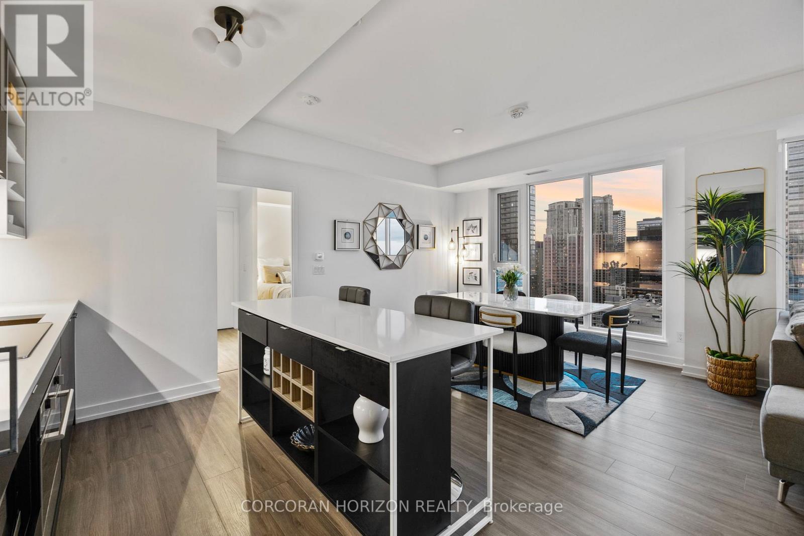 A well-lit, modern kitchen with a dining area and a city view.