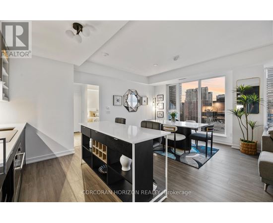 A well-lit, modern kitchen with a dining area and a city view.