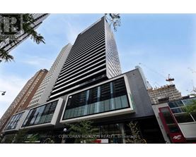 A tall building with a sign that says "CORCORAN HORIZON REALTY Brokerage" in front of it.