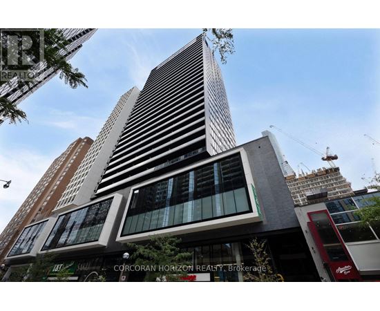 A tall building with a sign that says "CORCORAN HORIZON REALTY Brokerage" in front of it.