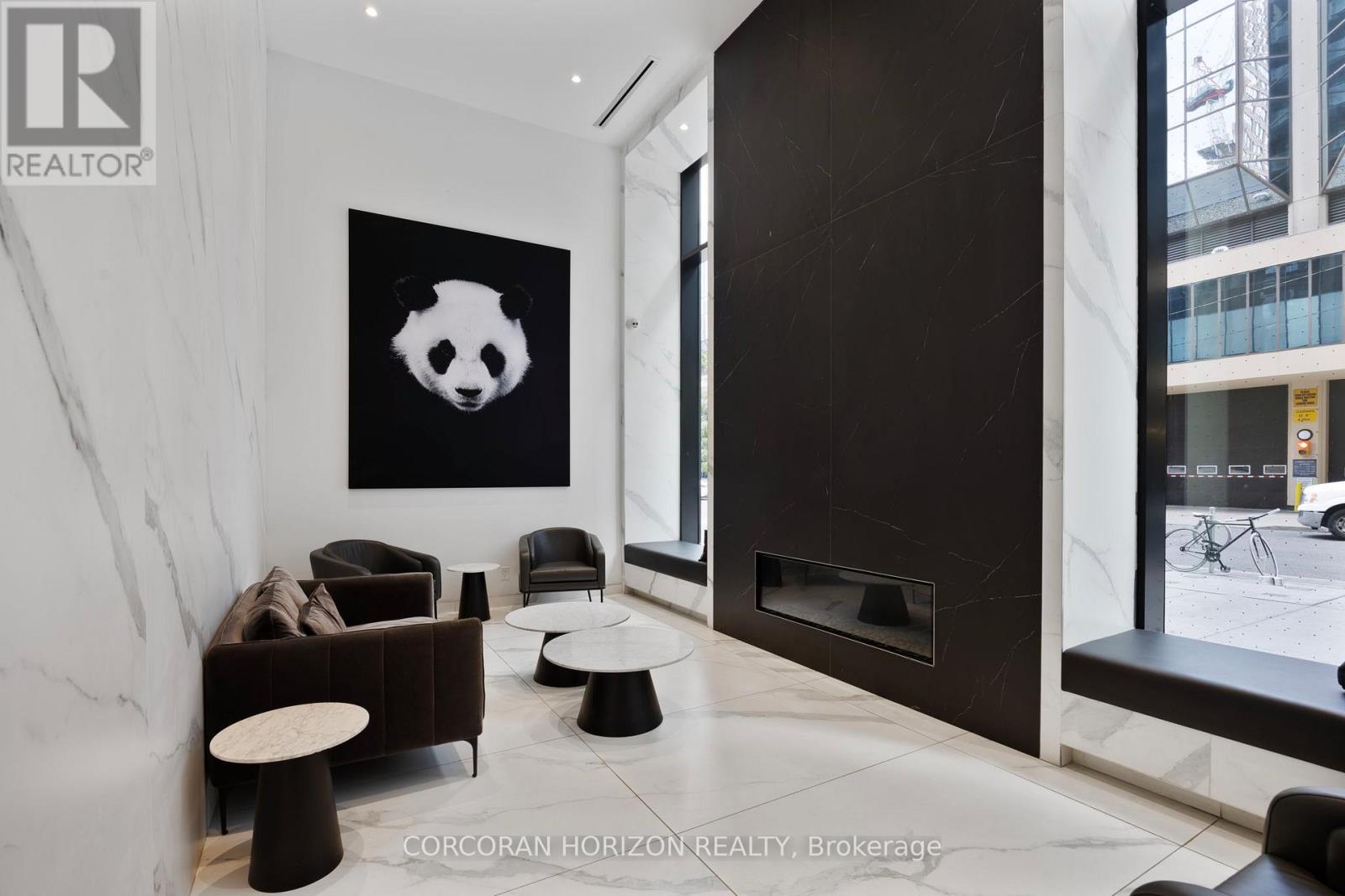 A living room with a panda painting on the wall.