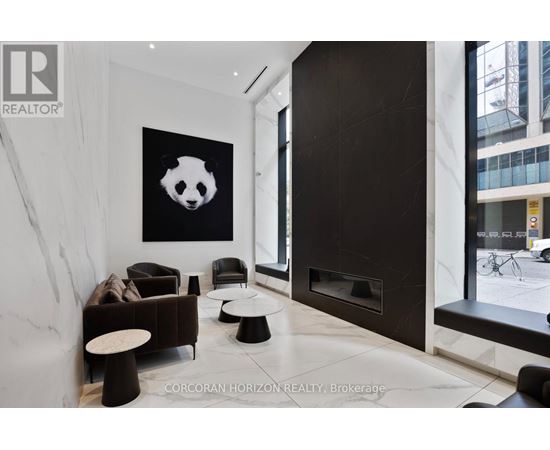 A living room with a panda painting on the wall.
