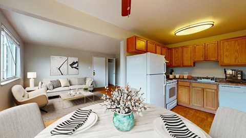 A kitchen with a white refrigerator and wooden cabinets.