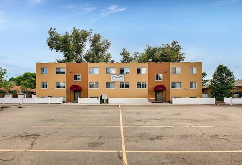 A large building with a parking lot in front of it.