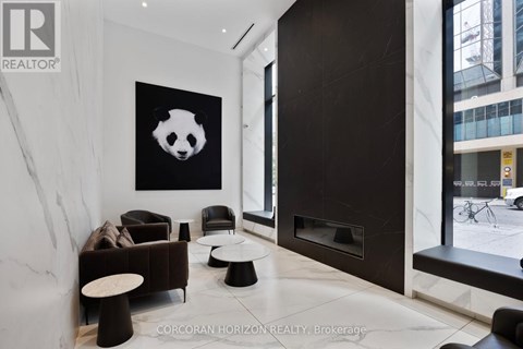 A living room with a panda painting on the wall.