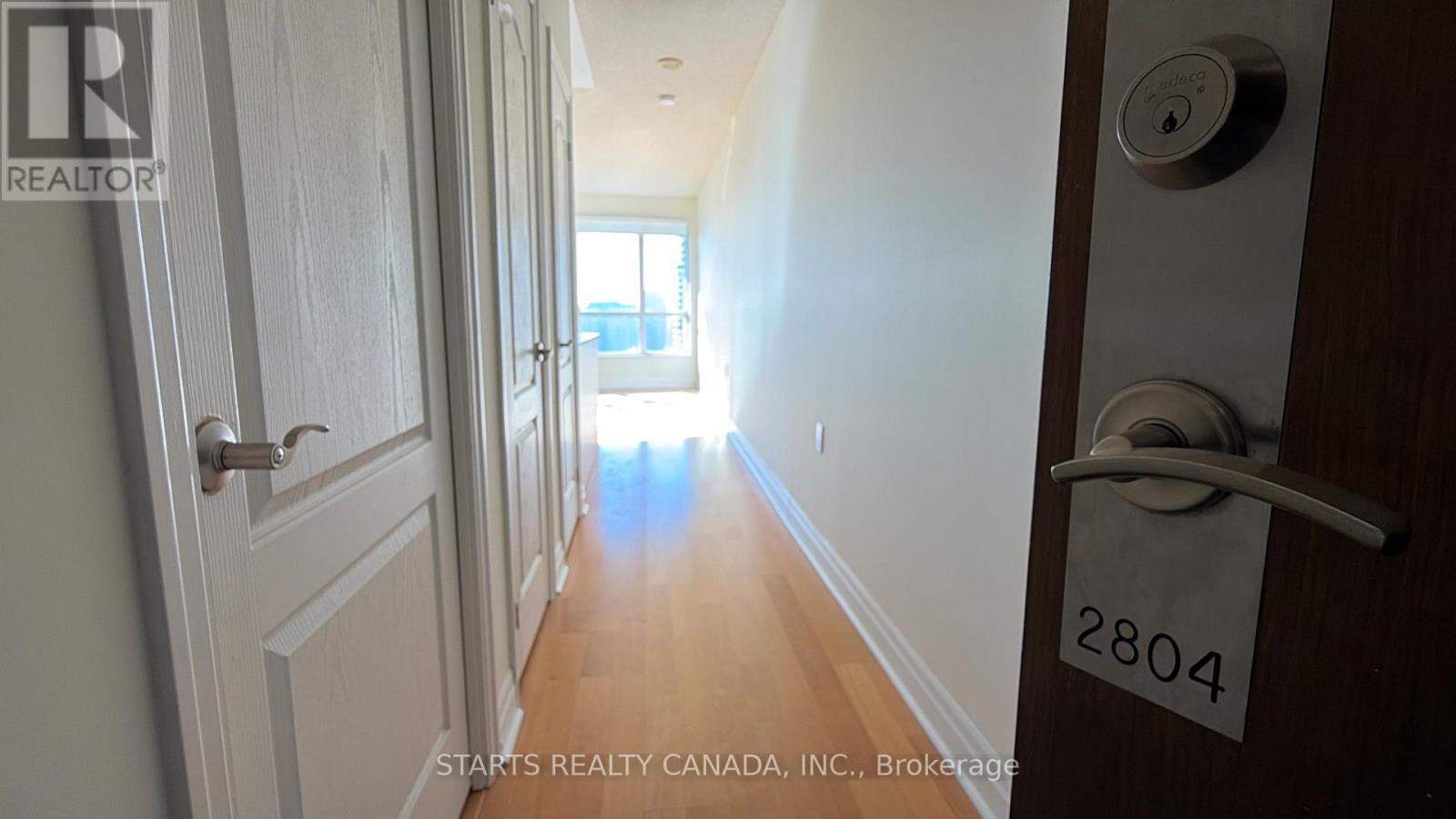 A hallway with a door on the right and a door on the left.