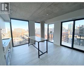 A large, empty room with a table and a view of the city.