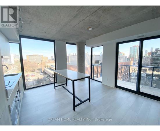 A large, empty room with a table and a view of the city.