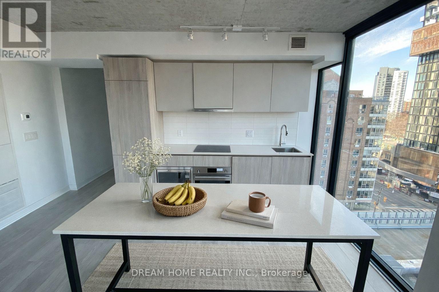 A modern kitchen with a breakfast setting on the table.