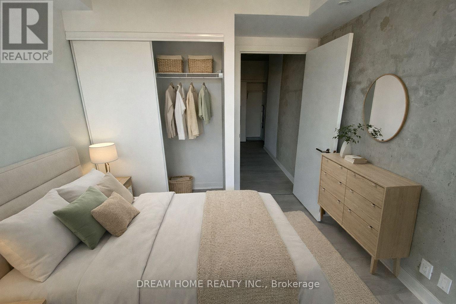 A bedroom with a large bed, a wooden dresser, and a mirror on the wall.