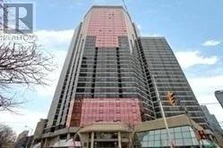 A tall building with a red section in the middle.