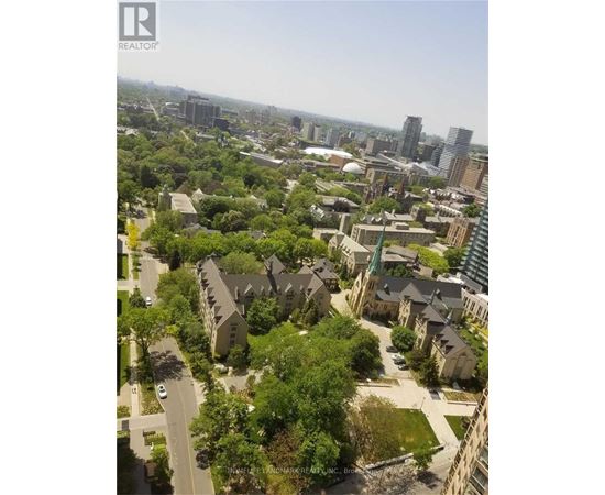 A bird's eye view of a residential area with houses and trees.