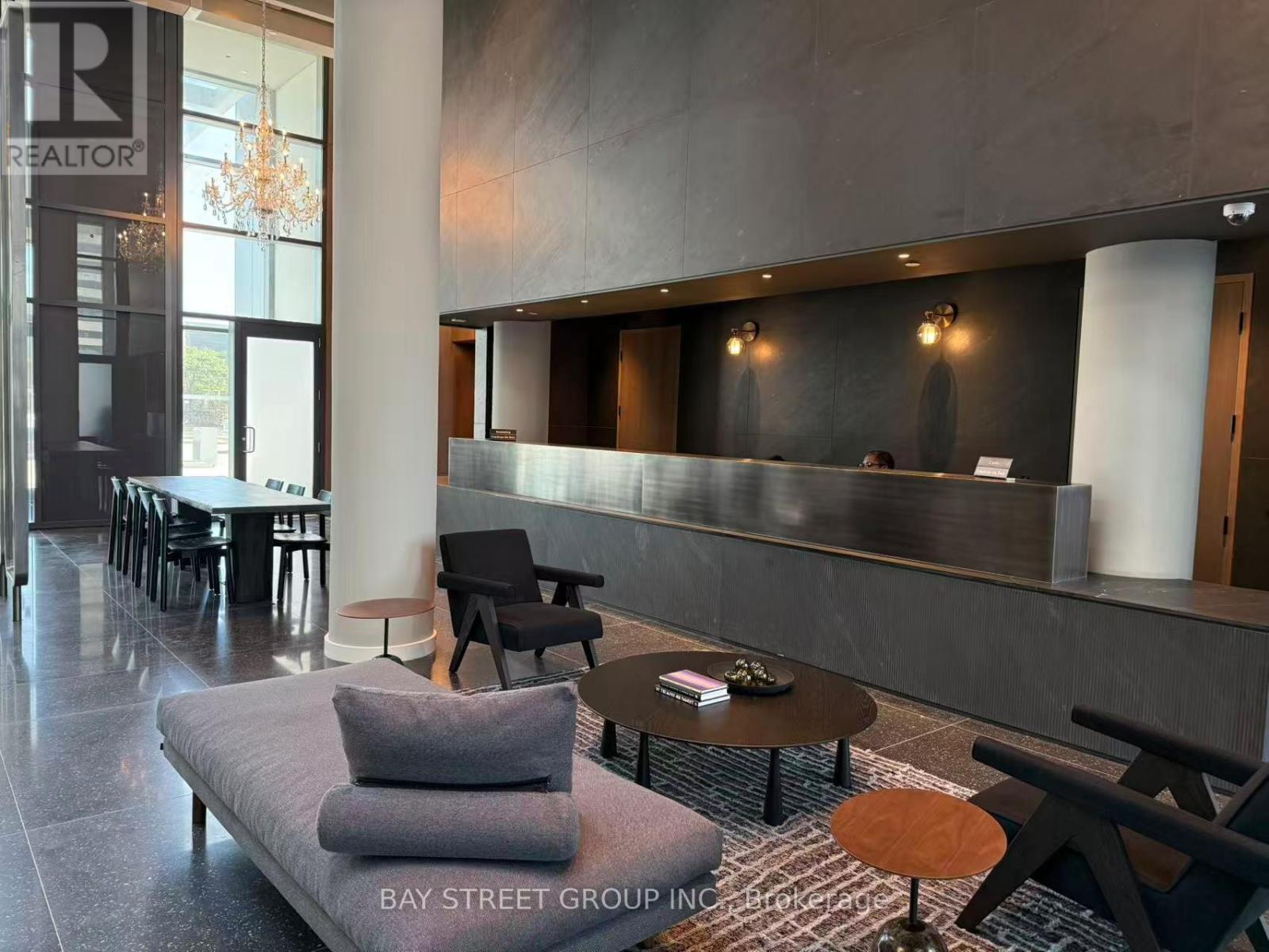A modern waiting area with a grey sofa and wooden coffee table.